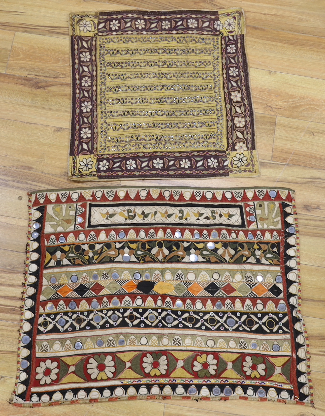 Two Indian embroidered and mirrored panels, possibly wall hangings, the largest 86cm x 67cm